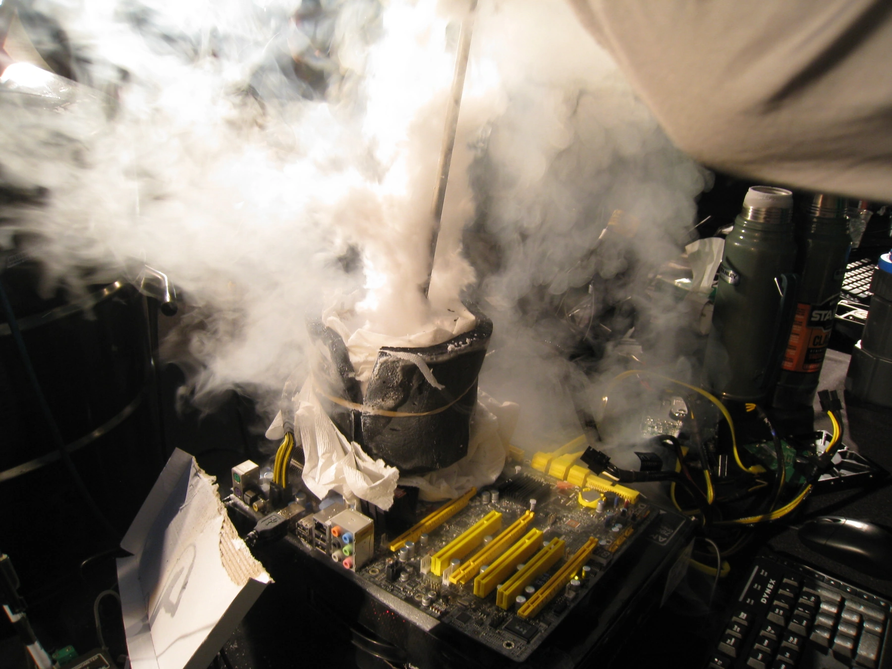 SF3D overclocking session — liquid nitrogen vapor rising from a motherboard mounted with an LN2 pot
